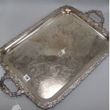 A large plated twin-handled rectangular tray, engraved, with foliate-cast edges