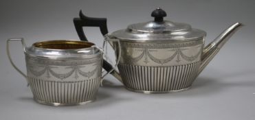 A Victorian silver swag-engraved teapot and matched sugar bowl, London 1884-5, makers Holland, Son &