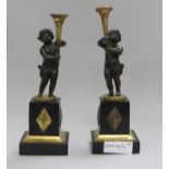 A pair of French bronze and gilt metal candlesticks