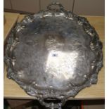 A large plated twin-handled engraved oval tray, the edges cast with foliate scrolling and flowers (