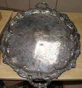 A large plated twin-handled engraved oval tray, the edges cast with foliate scrolling and flowers (