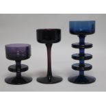 Stennet-Wilson for Wedgwood. A blue glass candlestick and two similar in amethyst glass