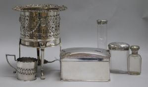 A silver plated bottle coaster, on reeded legs with paw feet, a plated biscuit box and three