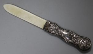 A late Victorian repousse silver handled ivory paper knife, 24.7cm.