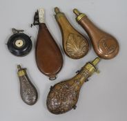 A leather shot flask, a copper powder flask (modern) with huntsman and dog, a copper powder flask,