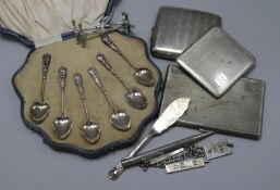 Three silver cigarette cases, a cased set of six silver teaspoons, a pair of silver knife rests