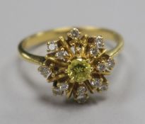 A fancy yellow and colourless diamond star-burst cluster ring, yellow metal shank (two small