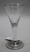 A wine glass, c.1740, with conical bowl over a plain stem, on a folded foot, 7.25in