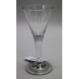 A wine glass, c.1740, with conical bowl over a plain stem, on a folded foot, 7.25in