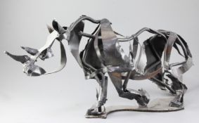 Clare S. Bigger. A modern metal sculpture of a rhino, signed, length 30in.