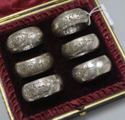 A cased set of six Victorian engraved silver napkin rings, Harrison Brothers, Sheffield, 1886/7.