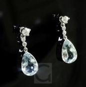 A pair of white gold, aquamarine and diamond drop earrings, set with pear shaped aquamarines, (later