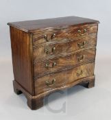 A George III mahogany serpentine chest, with straight sides and four graduated long drawers, on