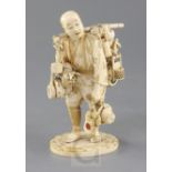 A Japanese inlaid ivory okimono of a street vendor, Meiji period, the figure supporting wares