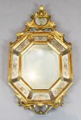 A late 19th century Venetian giltwood wall mirror, of octagonal cartouche form, the plates