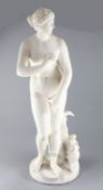 After the antique. A carved white marble figure of Venus standing alongside a dolphin ridden by