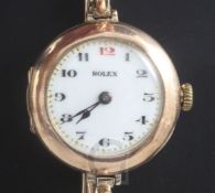 A lady's early 20th century 9ct gold Rolex manual wind wrist watch, with Arabic dial and red twelve,