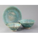 Two Kashan turquoise glazed pottery bowls and a similar dish, 13th century, both bowls incised
