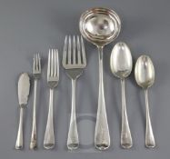 A part canteen of George V silver Hanovarian rat tail silver flatware by Walker & Hall, with