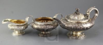 A George IV three piece embossed silver tea service of compressed melon form, William Hewitt? London