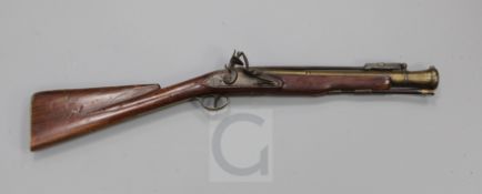 A late 18th century flintlock blunderbuss with sprung bayonet and brass barrel, the lock signed