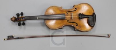 A violin bearing label for Maggini and date 1616, one piece back, cased with a gold mounted bow,
