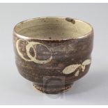 Manner of Shoji Hamada. A Studio pottery cup, with resist decoration of interlinked rings and leaf
