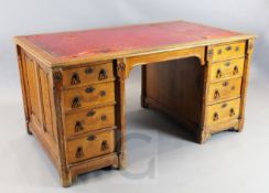 Gillows after a design by A.W.N.Pugin. A Victorian gothic revival oak desk, with nine drawers and