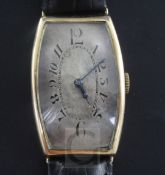 A gentleman's 1920's 9ct gold Regnia manual wind wrist watch, with tonneau case and silvered