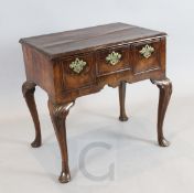 An early 18th century walnut and fruitwood lowboy, on foliate kneed cabriole legs, W.2ft 6in. D.