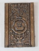A 17th century French oak panel, carved with a bust of a man within a cartouche, a supporting figure