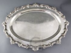 A George IV silver oval meat dish by William Eaton?, with foliate scroll border and engraved
