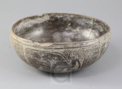 A pre-Columbian black ware bowl, Peru, incised with stylised bird figures and bands with cross-