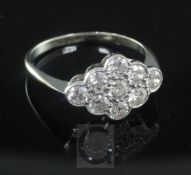 An 18ct gold, platinum and nine stone diamond cluster ring, of marquise shape, size Q.