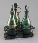 A Regency gilt decorated green glass three bottle decanter stand, each bottle with tear drop