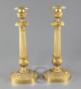 A pair of French Empire style ormolu candlesticks, with fluted stems banded with flowers, height