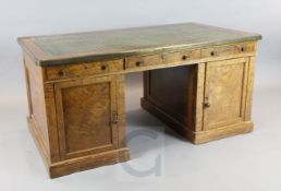 A Victorian brass bound pollard oak partner's desk, with green skiver, six frieze drawers and four