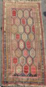 A Kazak multi-coloured rug, late 19th century, with field of polychrome hexagons and five row