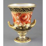 A Derby Campana shaped vase, c.1810, painted in iron red with a band of roses on a gilt ground