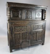 A late 17th century oak court cupboard, the frieze dated 1687, carved with foliate motifs, W.5ft