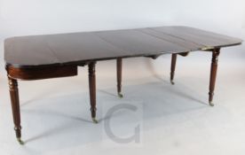 A Regency mahogany concertina action extending dining table, with D shaped folding top and two spare