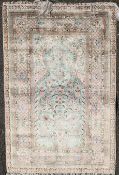 An Isfahan style silk rug, decorated with birds and flowers on an ivory ground, 5ft by 3ft 5in.