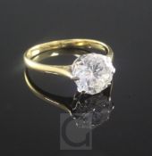 An 18ct gold and solitaire diamond ring, the round brilliant cut stone weighing approximately in