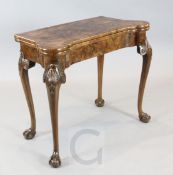 A fine George I figured walnut card table, with minute feather banding around the interior top