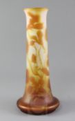 A tall Galle cameo glass vase, c.1900, decorated with lilies in amber over frosted clear glass,