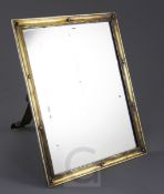 A late 19th/early 20th century continental silver gilt easel mirror, engraved with large eagle crest