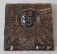 A 17th century oak panel, carved with the sun, within radiating "rays", 9.5 x 10in.