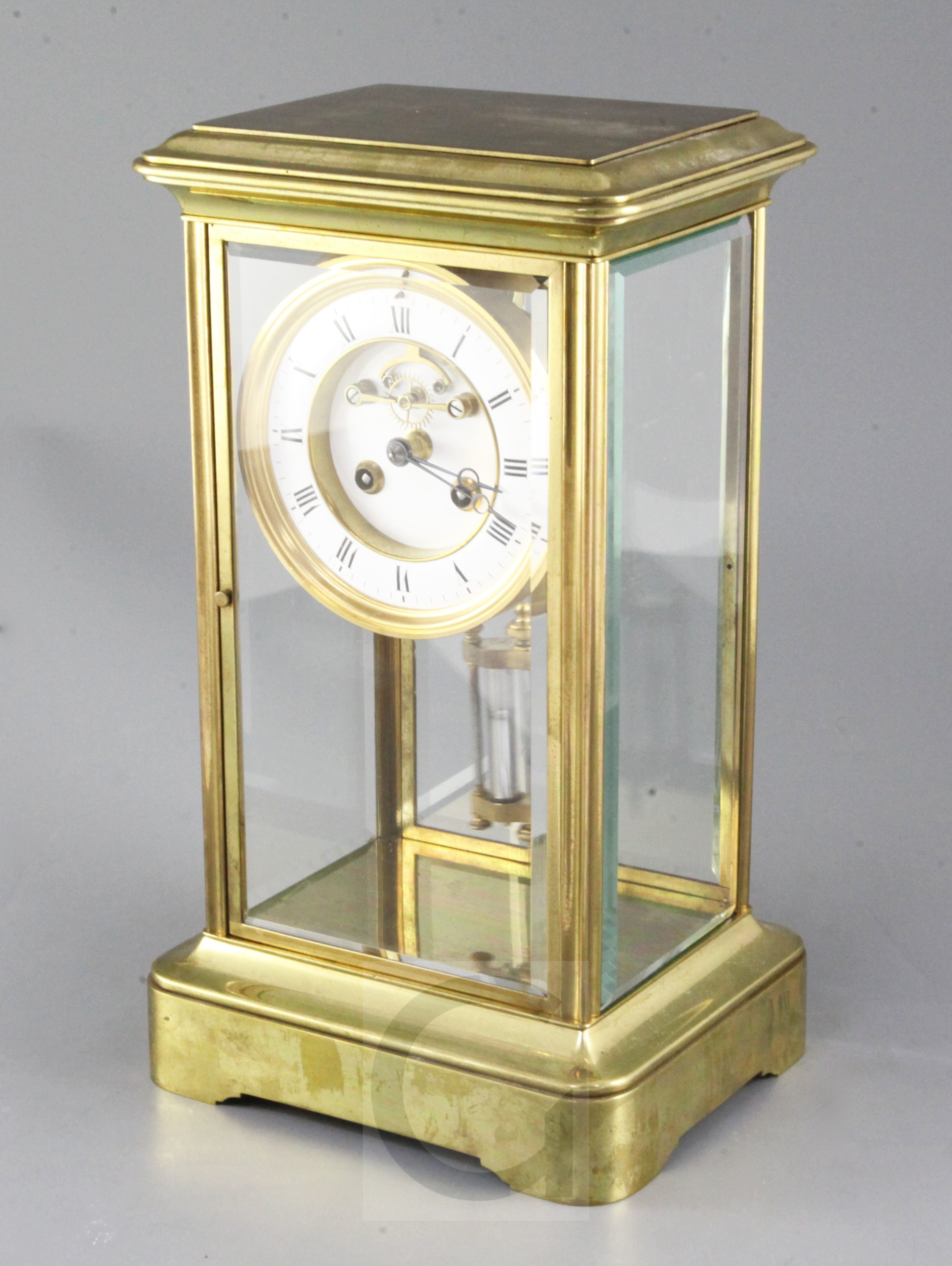 An early 20th century French four glass mantel clock, with visible escapement and mercury
