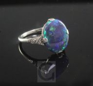 A 1940's 18ct white gold, platinum and black opal ring with diamond set shoulders, size M.