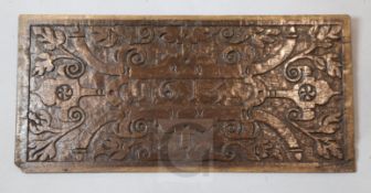 A James I oak panel, carved with stylised foliage in low relief and dated 1615, 22.5 x 10in.